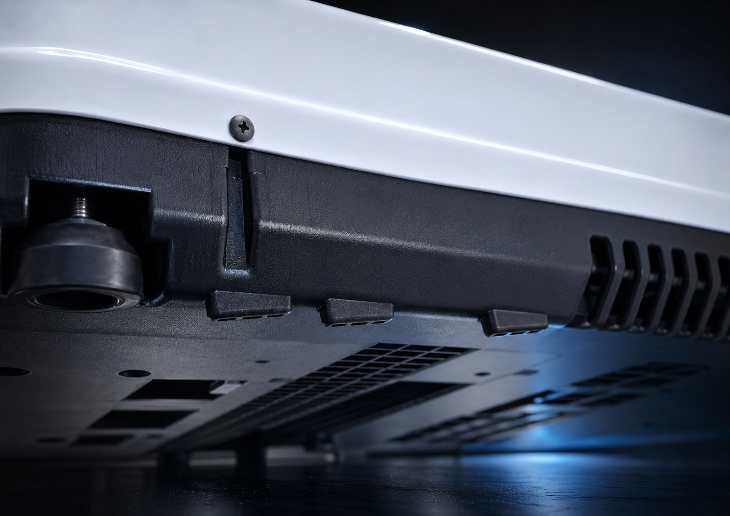 X2 Helix Gen II rooftop air conditioner underside showing black base, integrated leveling foot, and directional water-management fins.