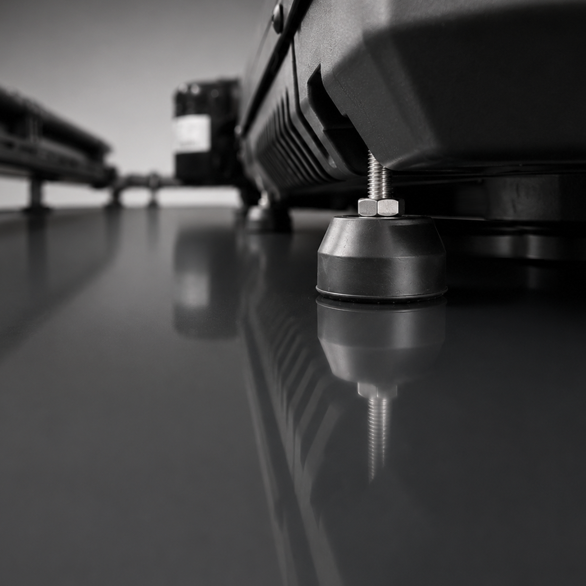 Close-up of the X2 Helix Gen II rooftop air conditioner adjustable leveling foot under the black lower base.